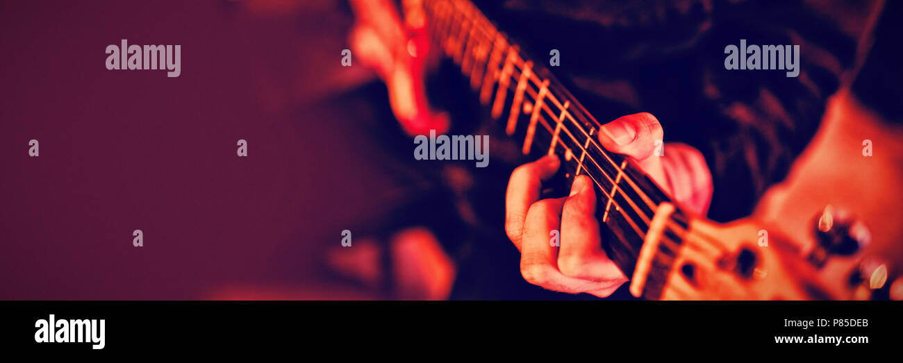 Mid-section of man playing guitar Stock Photo