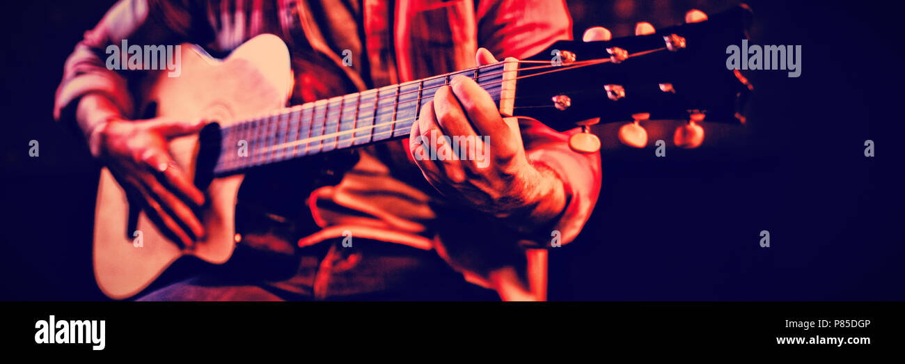 Mid-section of man playing guitar Stock Photo