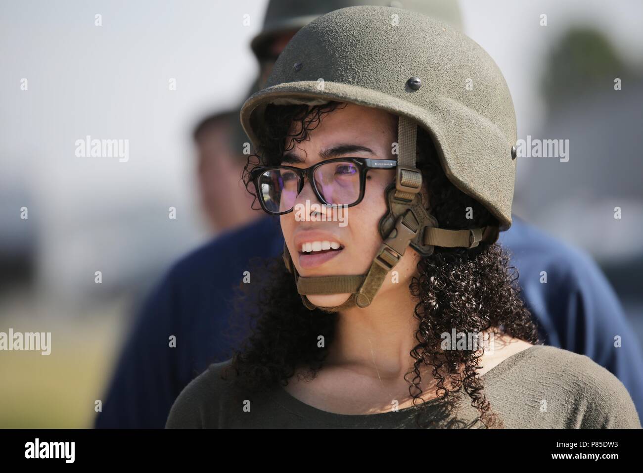 QUANTICO, Va. - Gina Ibrahim waits for her group to be called into the Leadership Reaction Course (LRC) at Officer Candidates School (OCS) during Marine Corps Recruiting Command's 2018 Educators and Key Leaders Workshop aboard Marine Corps Base Quantico, Virginia, June 19, June 19, 2018. The workshop established mutually beneficial relationships between Marine officer selection officers and educators, community leaders and educators experienced a trip to Quantico in efforts to develop their leadership skills and learn about career opportunities in the Marine Corps. Ibrahim is a career services Stock Photo