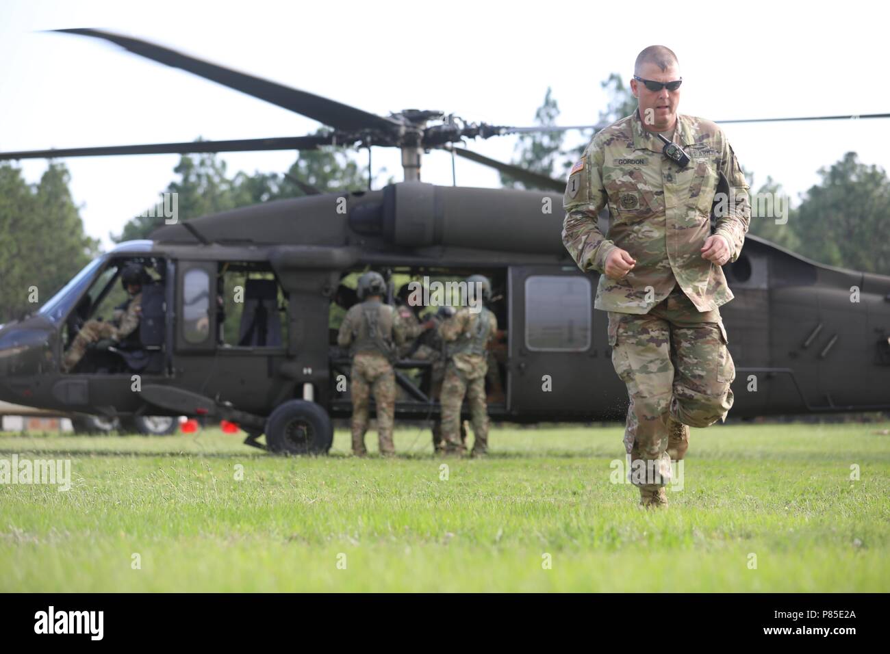 A cadre member departs from the UH-60 Black Hawk helicopter during the Operation Order Event at the 2018 U.S. Army Reserve Best Warrior Competition at Fort Bragg, North Carolina, June 13, 2018, June 13, 2018. U.S. Army Reserve Soldiers compete all day and into the night, pushing themselves at every event during the six-day 2018 U.S. Army Reserve Best Warrior Competition. (U.S. Army Reserve photo by Spc. Devin A. Patterson) (Released). () Stock Photo