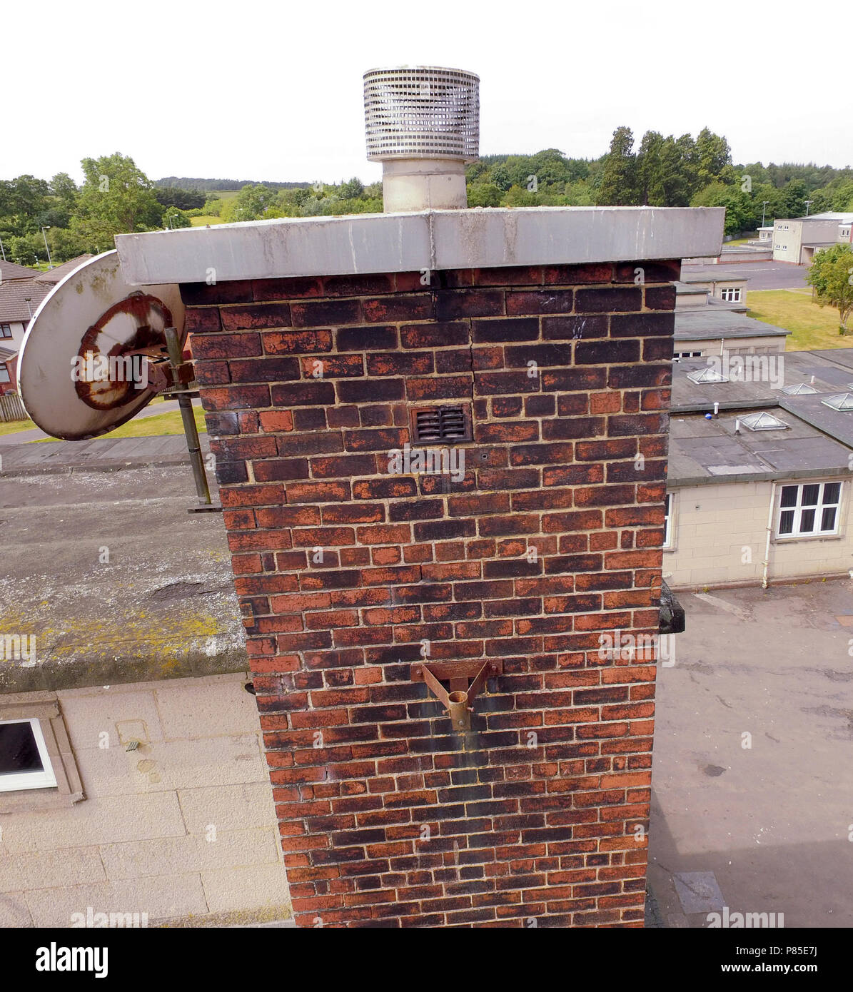 Drone photo of crack in brick chimneyhead Stock Photo