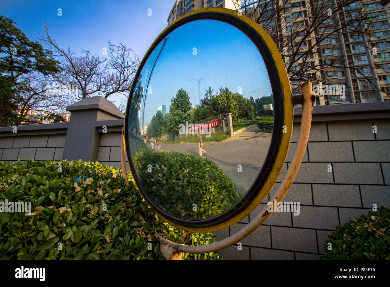 Outside View Reflection Reflection from a convex mirror outside a driveway an an apartment ...