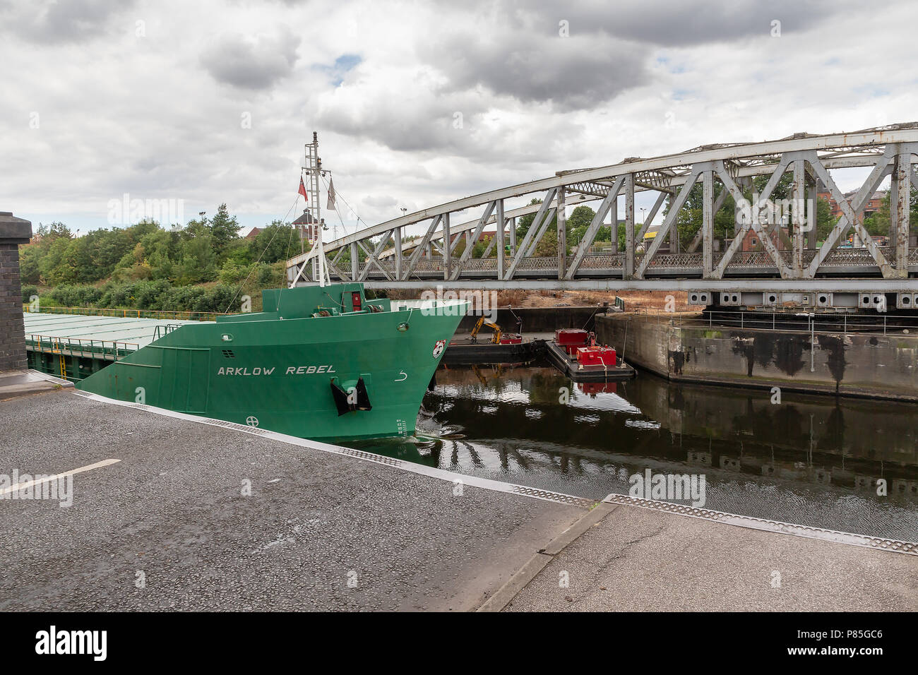Arklow Rebel, a 13 year old General Cargo Ship from Ireland travels along the Manchester Ship Canal, through the open Swing Bridge at Stockton Heath Stock Photo