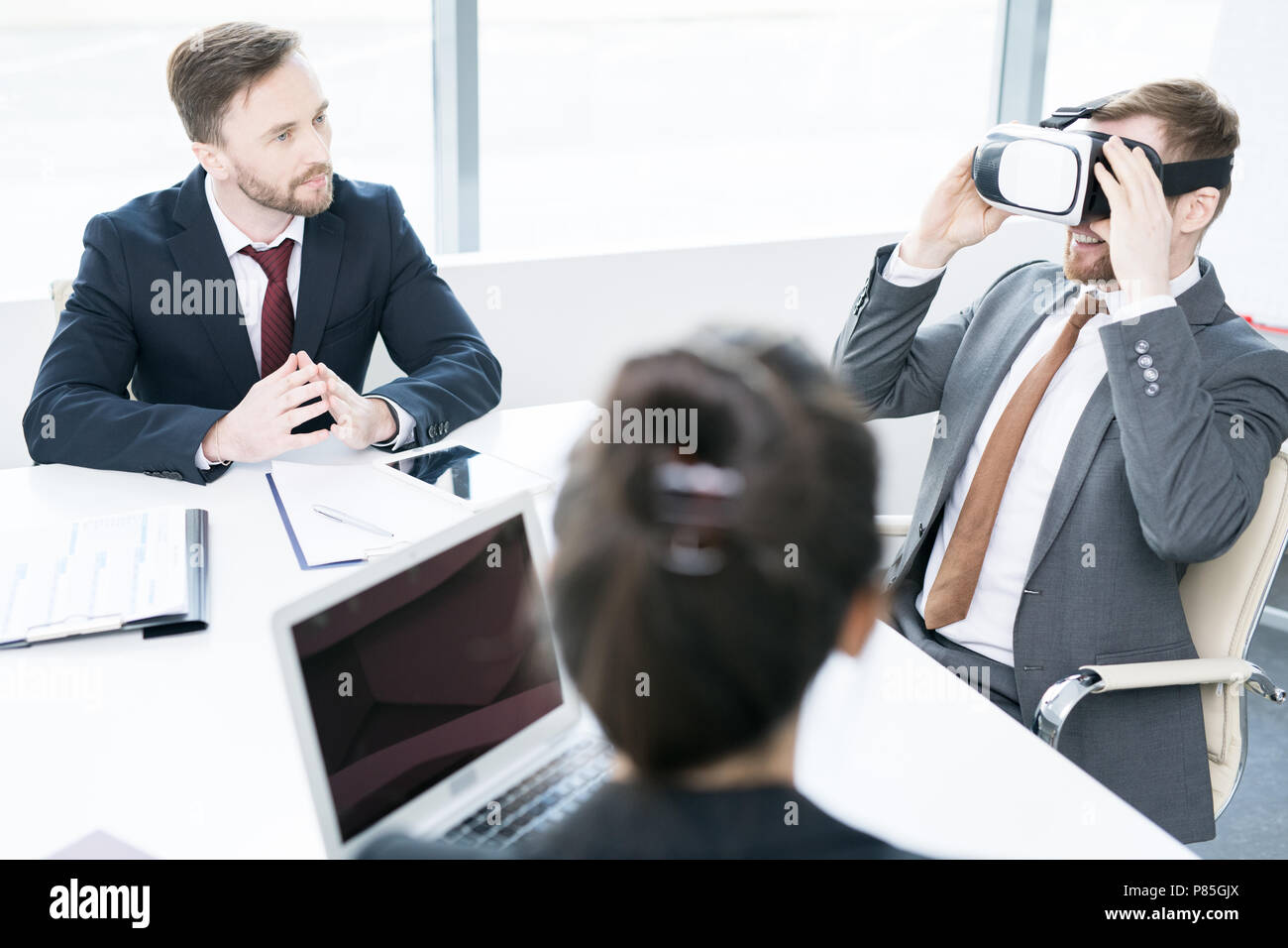 Businessman Using VR in Meeting Stock Photo