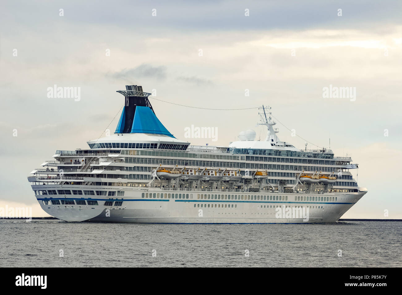 White cruise liner sailing to the Baltic sea in cloudy day Stock Photo