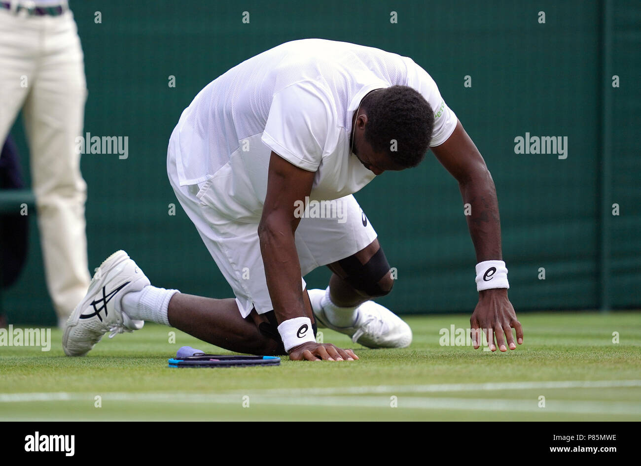 Monf Gael Monfils slips during his match on day seven of the Wimbledon ...