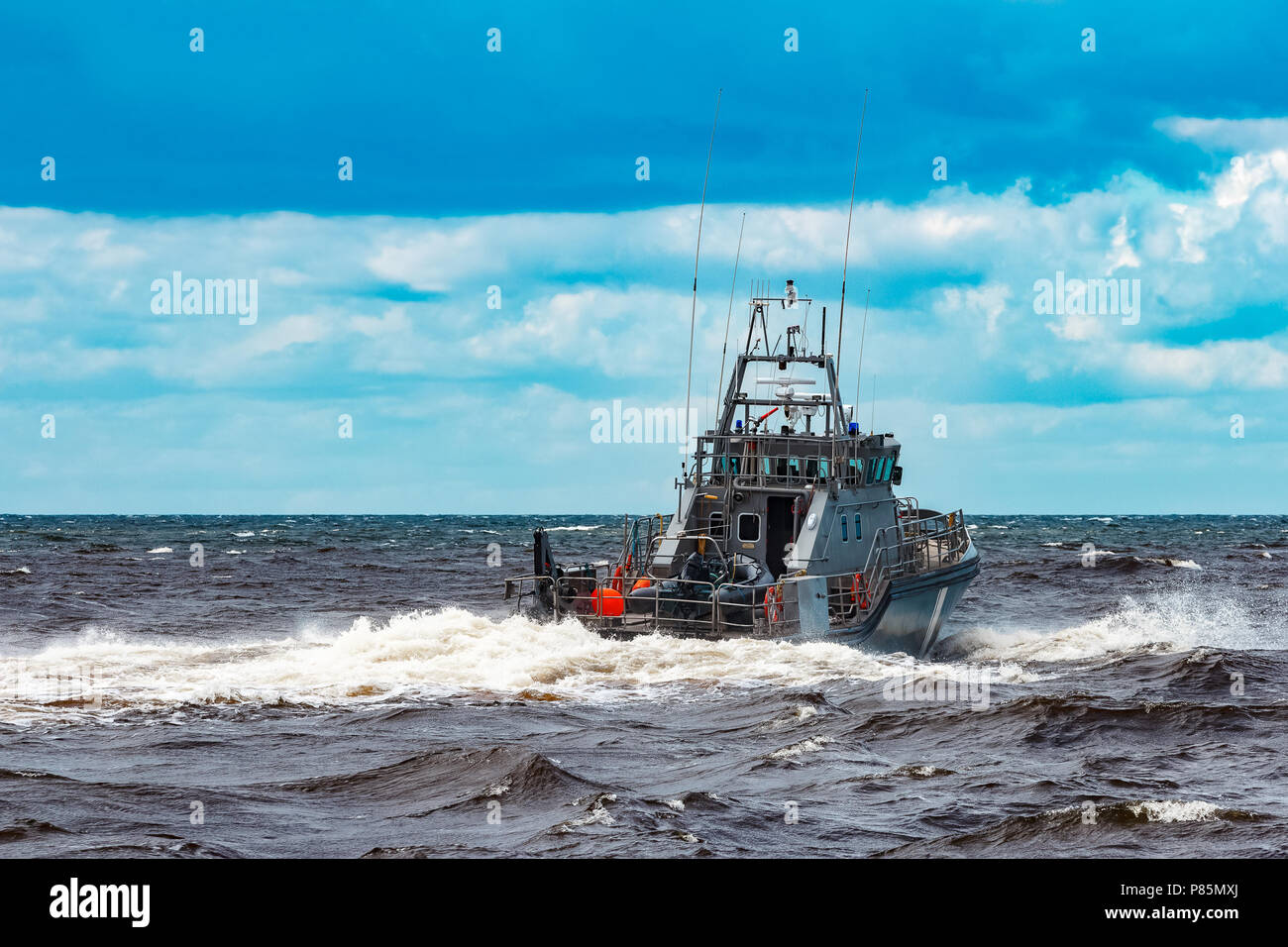 Grey military ship sailing at Baltic sea. Border guard service Stock Photo