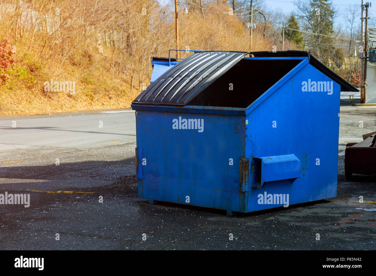 Industrial garbage bin blue construction debris container filled with