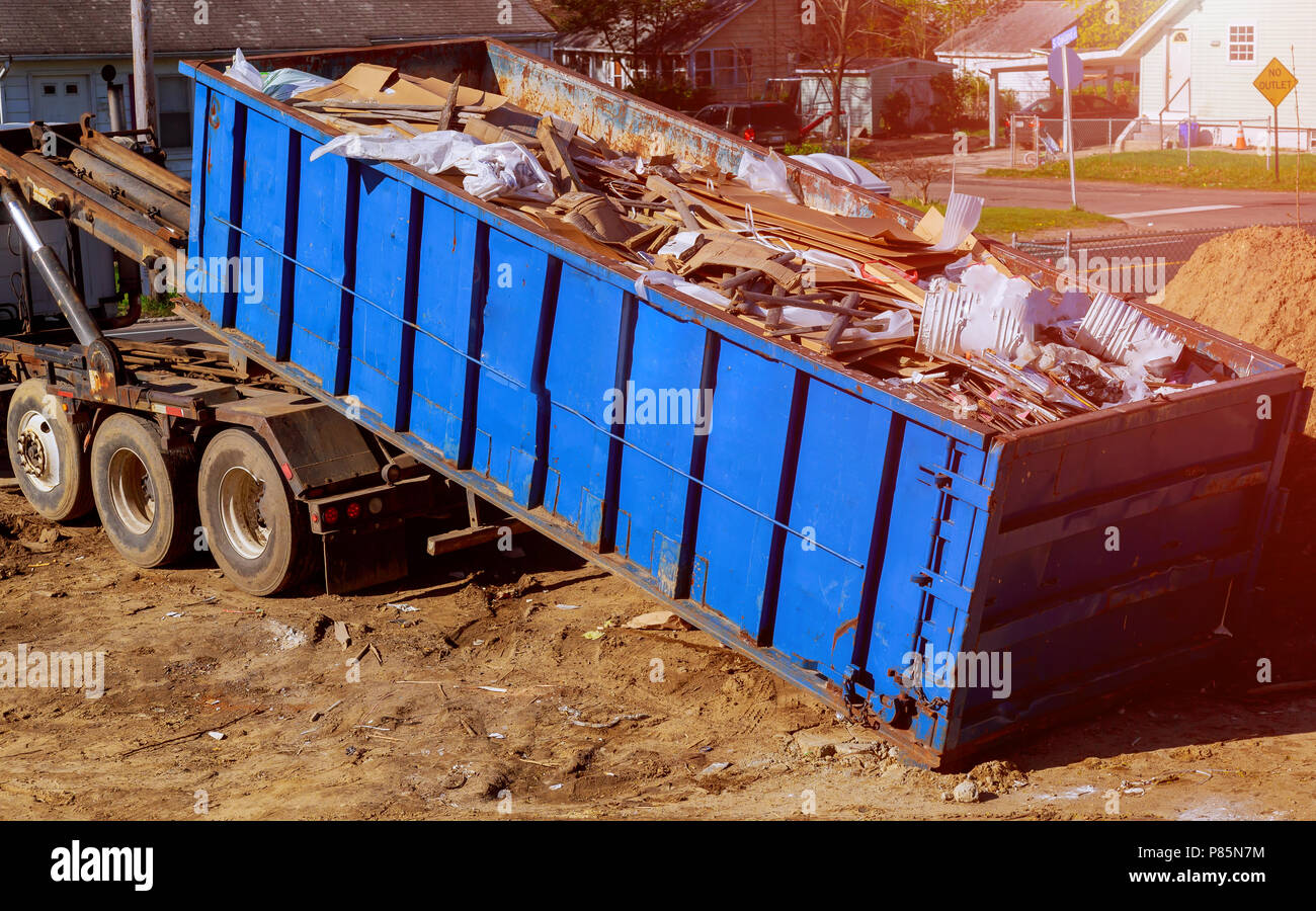 Industrial garbage bin blue construction debris container filled with