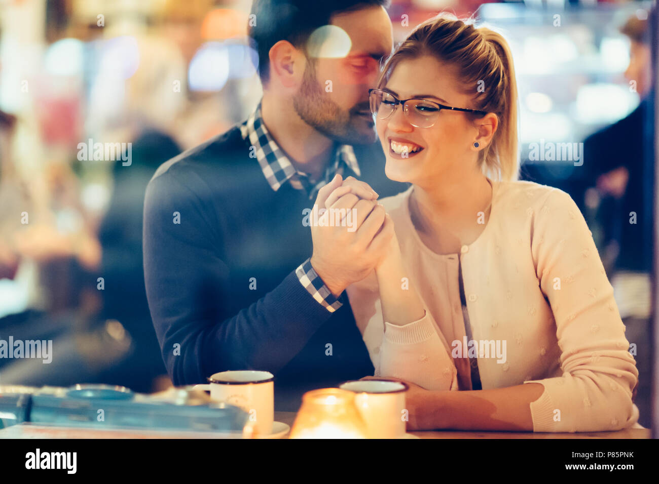 Romantic couple dating in pub at night Stock Photo