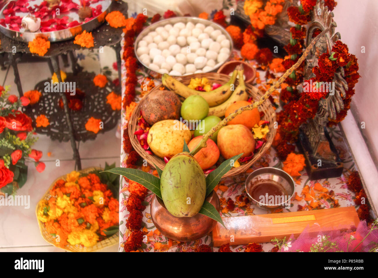 Hindu puja, offering to gods. Incense, fruits, sweets, rose petals