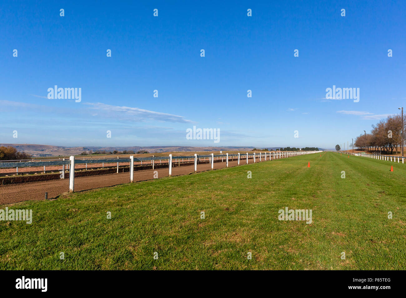 Horse Racing Track Railing Race horse grass and sand training track looking down long straight ...