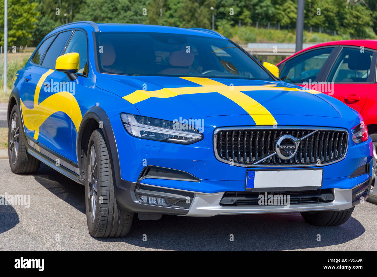 Parked cool Volvo car wrapped in blue and yellow swedish flag Stock Photo