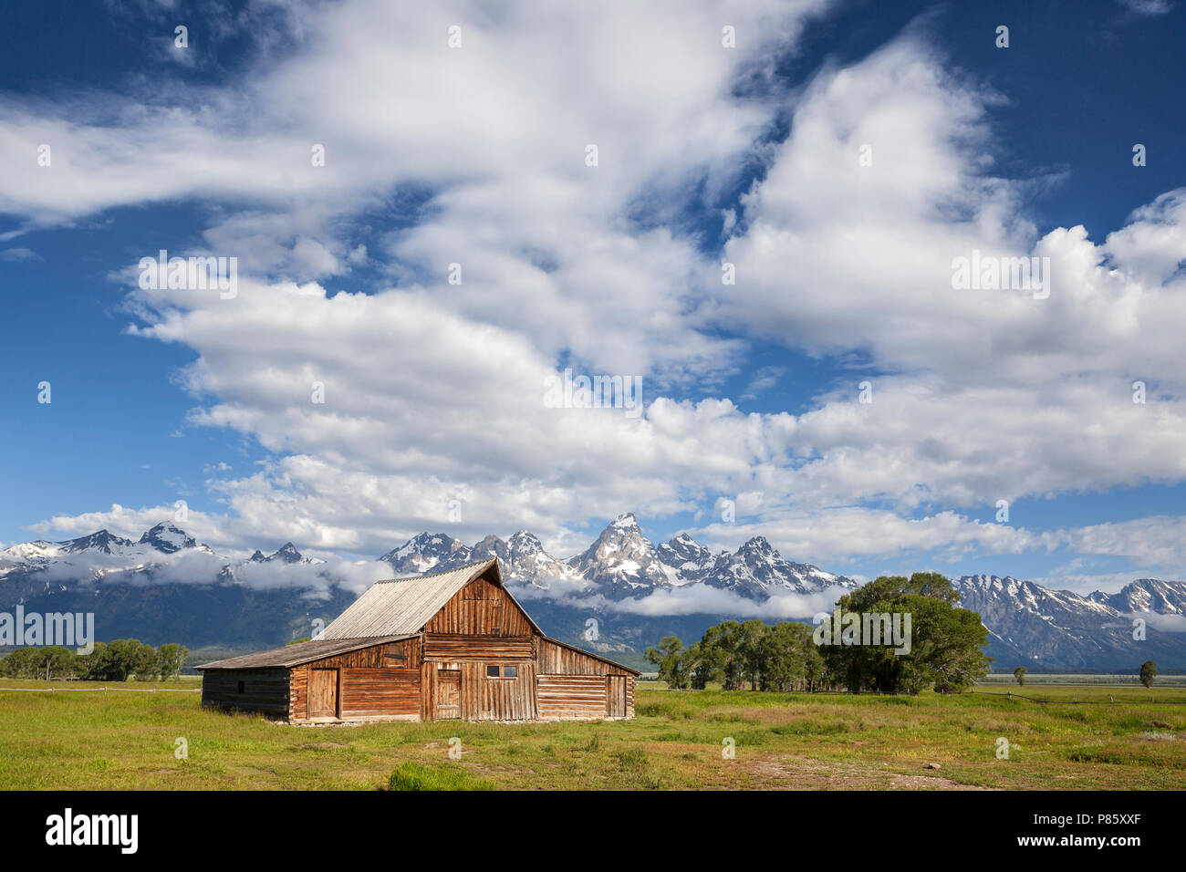 WY02772-00...WYOMING - Historic buildings in Grand Teton National Park along Mormon Road with the Teton Range in the background. Stock Photo