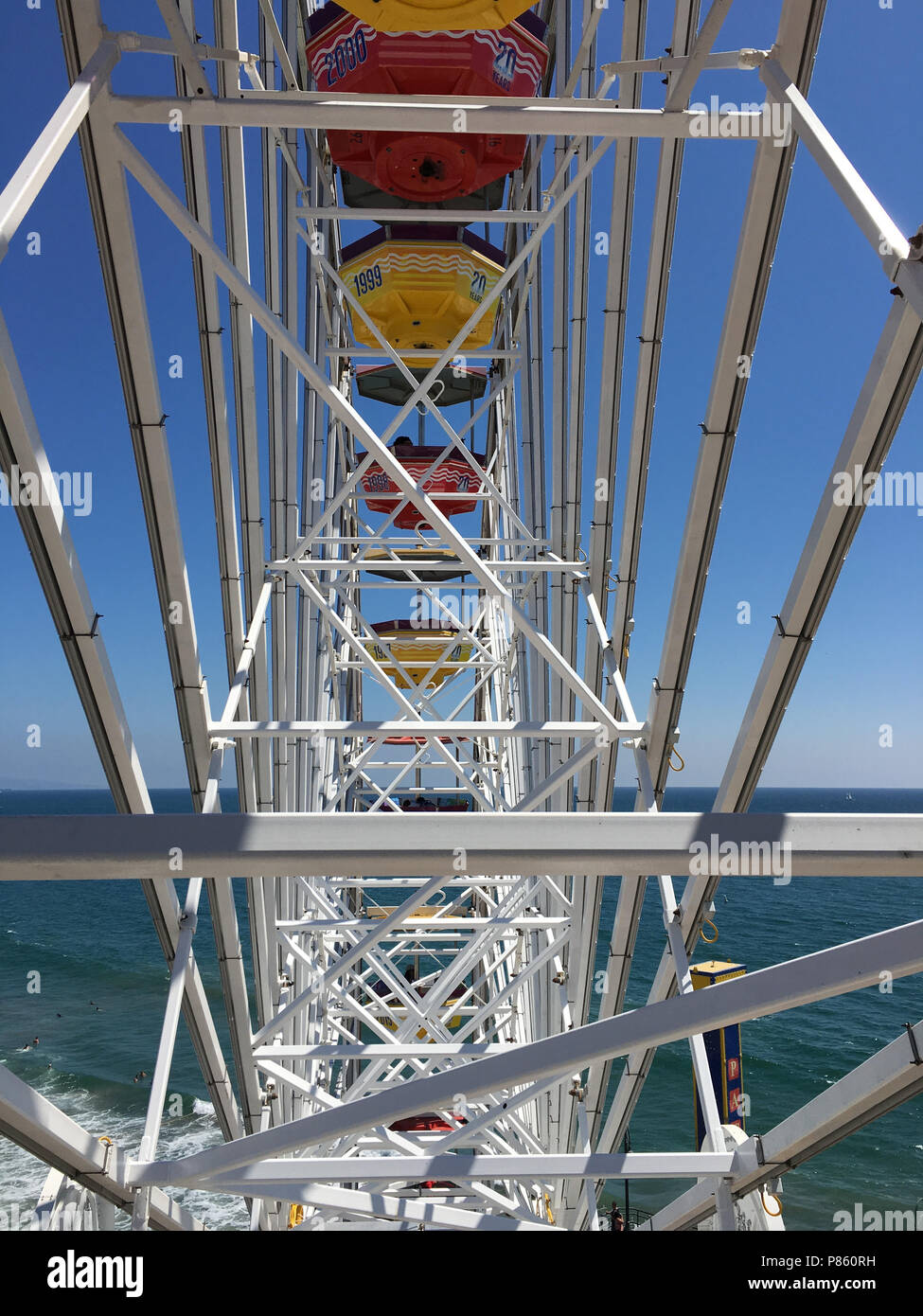 Close up view of a bright Ferris Wheel with clear blue sky background ...