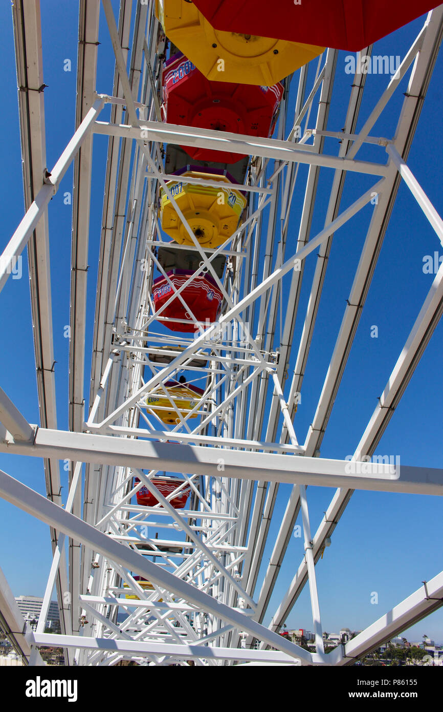 Close up view of a bright Ferris Wheel with clear blue sky background ...