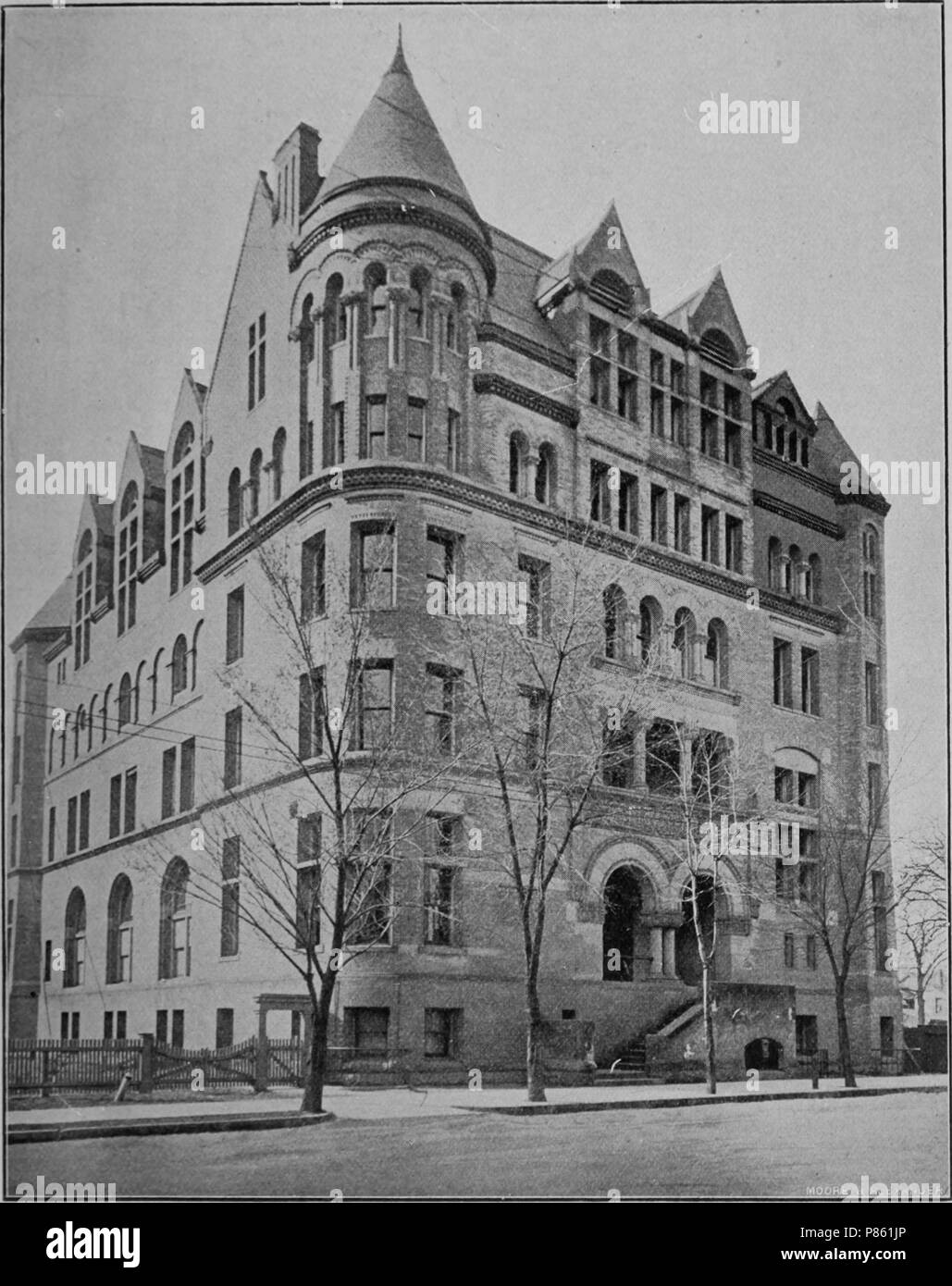 Black and white print illustrating an angled view of the Technical School, a multi-level Romanesque Revival structure with a corner tower, located on College Street in Toronto, Canada, 1903. Courtesy Internet Archive. () Stock Photo