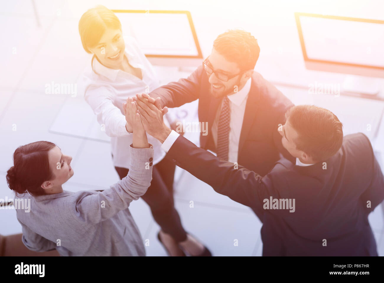 successful business team giving each other a high-five, standing in the ...