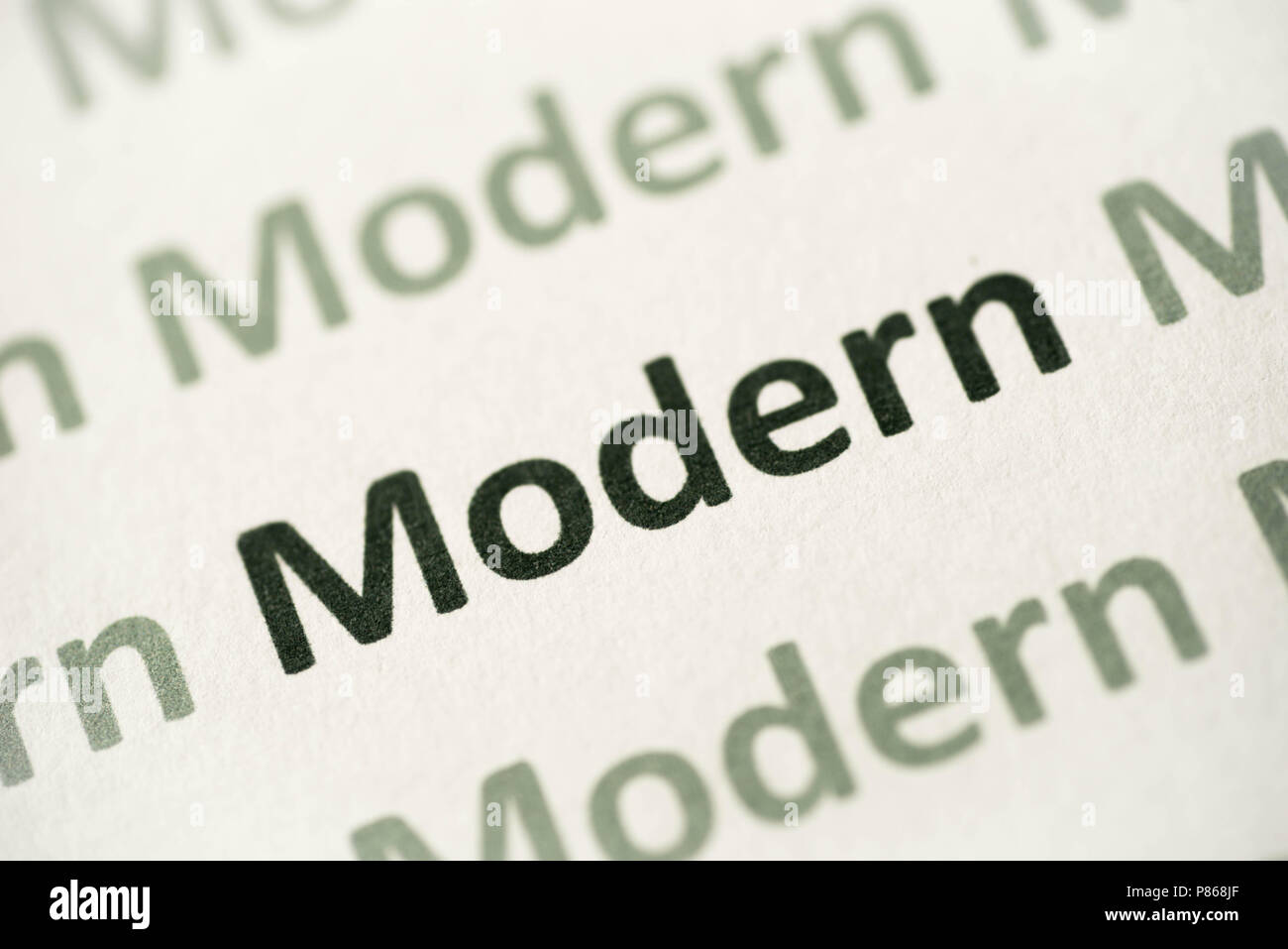 word modermn printed on white paper macro Stock Photo