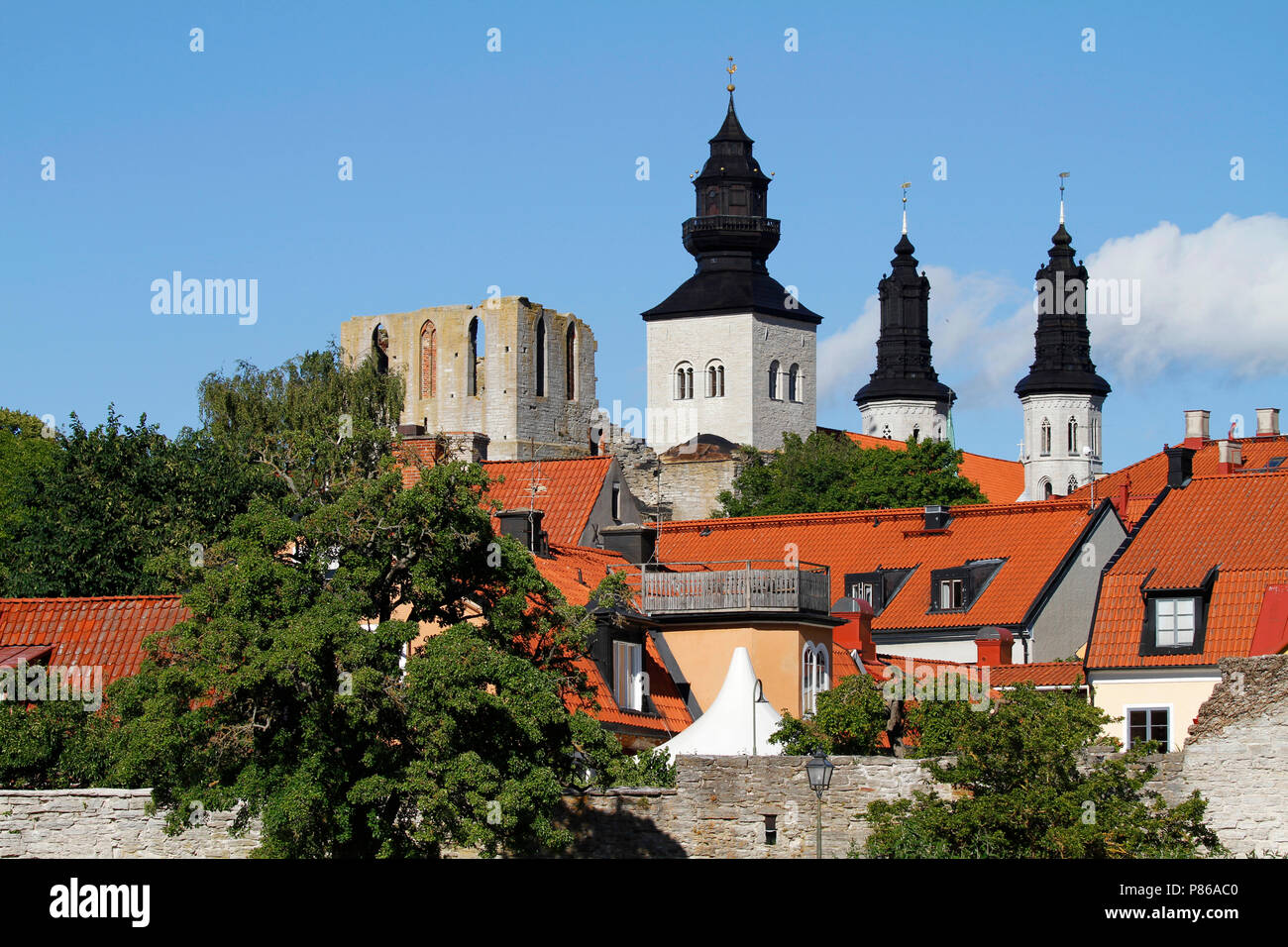 Towers of the Visby cathedral over the roof tops of medieval hanseatic town in Gotland Island, Sweden. Stock Photo
