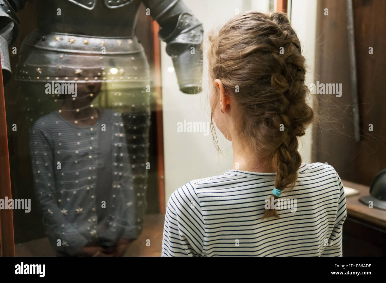 Little girl exploring expositions in museum. Stock Photo