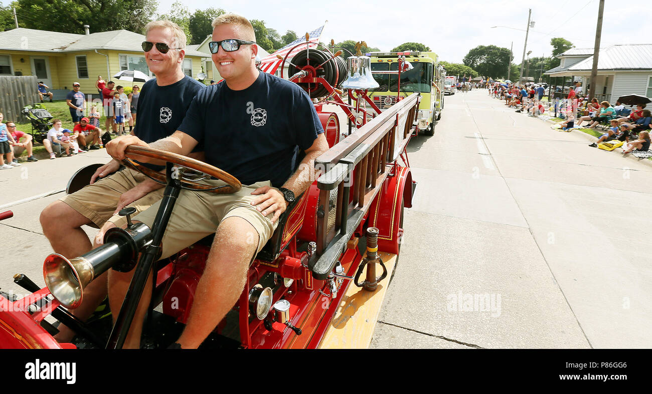 Bettendorf, Iowa, USA. 4th July, 2018. Austin, right and Rod Blunk with the Bettendorf Fire Department drive the departments first fire truck along Grant Street during the Fourth of July parade in Bettendorf, Iowa Wednesday, July 04, 2018. The American LaFrance Brockway Torpedo, a 1922 model, came from Elmira, N.Y. It was purchased by the city of Bettendorf in 1924 for $6,000 and delivered by train in early November of that year. Credit: Kevin E. Schmidt/Quad-City Times/Quad-City Times/ZUMA Wire/Alamy Live News Stock Photo