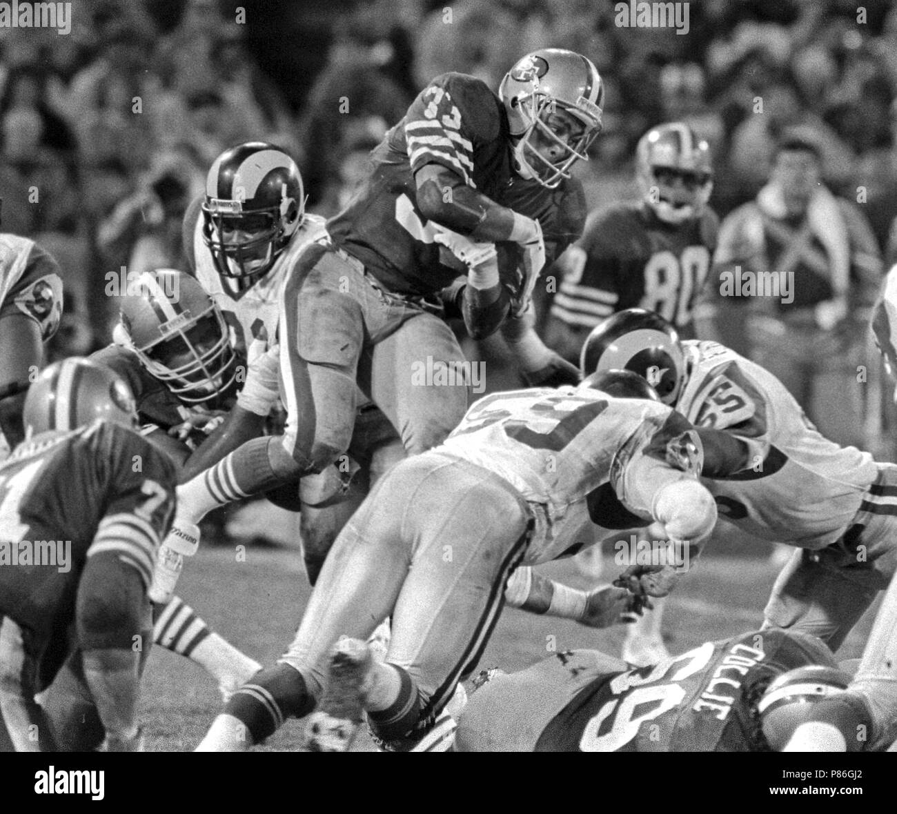 December 19, 1986 - San Francisco, California, U.S - San Francisco 49ers vs. Los Angles Rams at Candlestick Park Friday, December 19, 1986. 49ers Beat Rams 24-14. San Francisco 49ers Running Back Roger Craig (33) fly through defenders. (Credit Image: © Al Golub via ZUMA Wire) Stock Photo