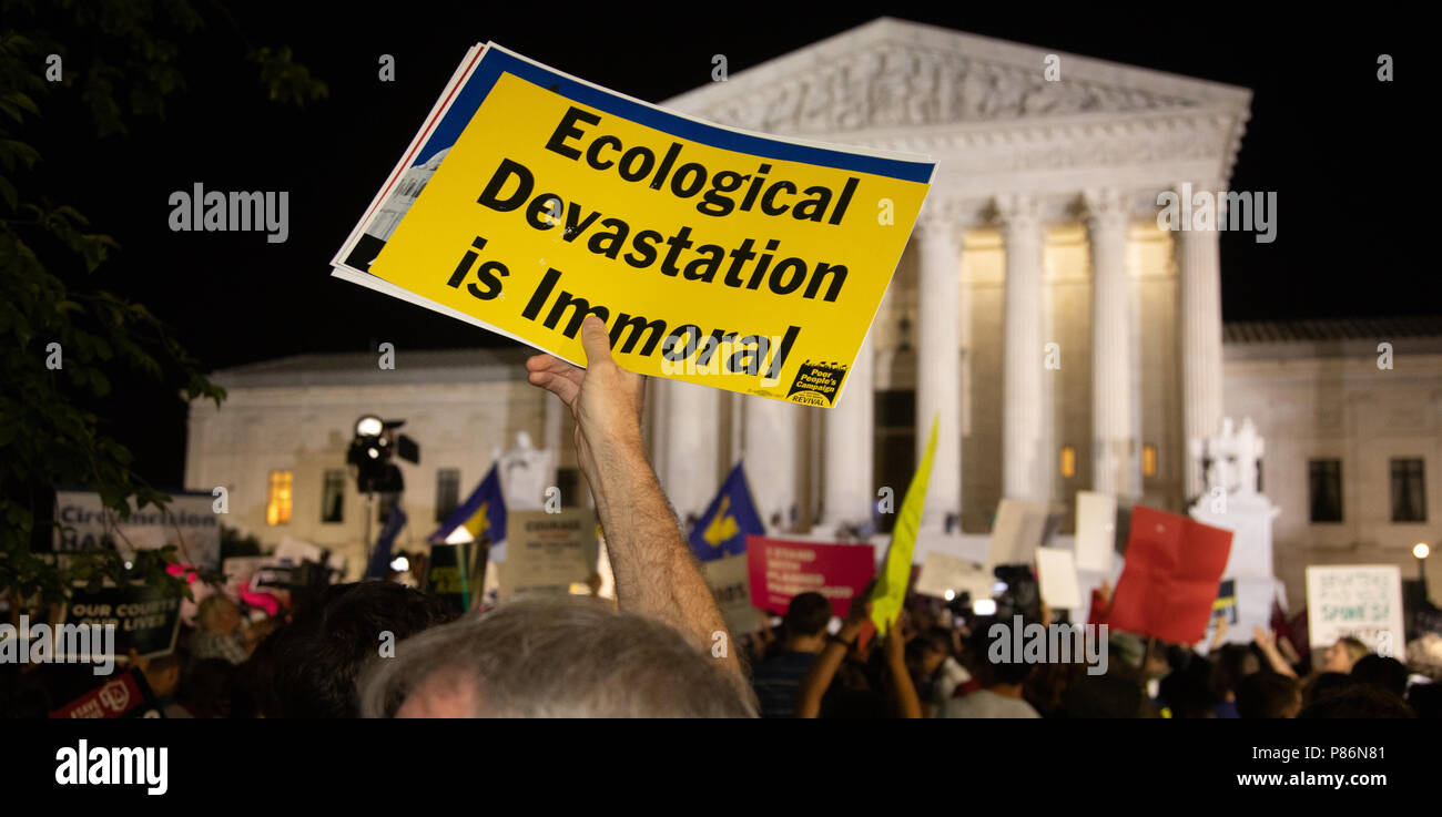 Washington, United States Of America. 09th July, 2018. 'Ecological devastation is immoral' reads the sign. Hundreds assembled in front of the U.S. Supreme Court in Washington, DC to protest Brett Kavanaugh, President Donald Trump's nominee to replace Justice Anthony Kennedy, on Monday night, July 10, 2018. (Photo by Jeff Malet) Photo via Credit: Newscom/Alamy Live News Stock Photo