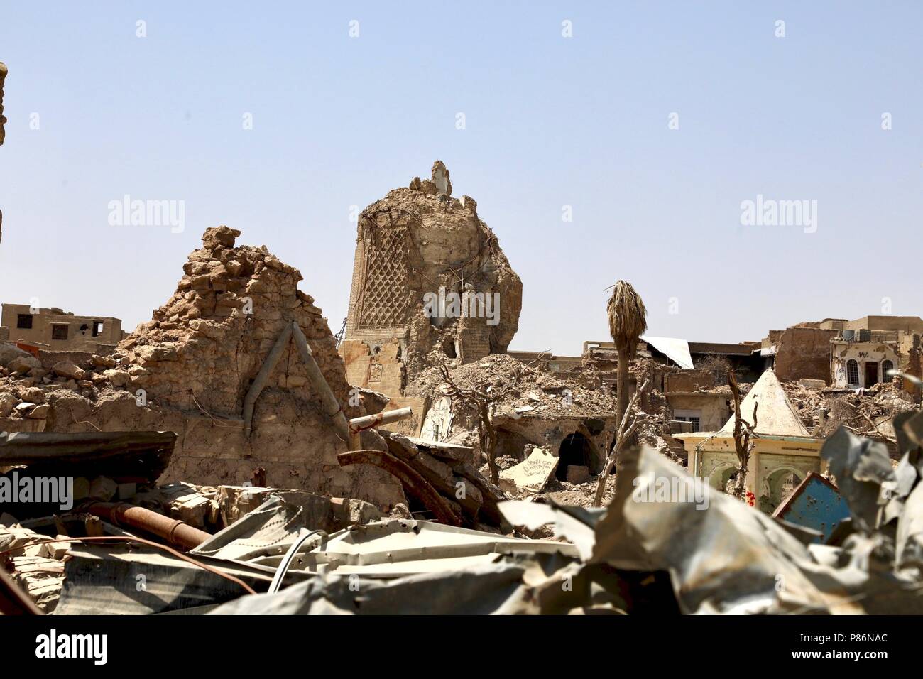Mosul. 5th July, 2018. Photo taken on July 5, 2018 shows the destroyed leaning minaret of al-Nuri mosuqe in the old city of Mosul, Iraq. One year after the Iraqi forces liberated the city of Mosul from Islamic State (IS) militants, tens of thousands of displaced residents are still living in tents, suffering the scorching summer with a temperature of over 50 degrees Celsius. TO GO WITH Feature: One year on, tens of thousands of Iraqis remain displaced from homes in Mosul Credit: Khalil Dawood/Xinhua/Alamy Live News Stock Photo