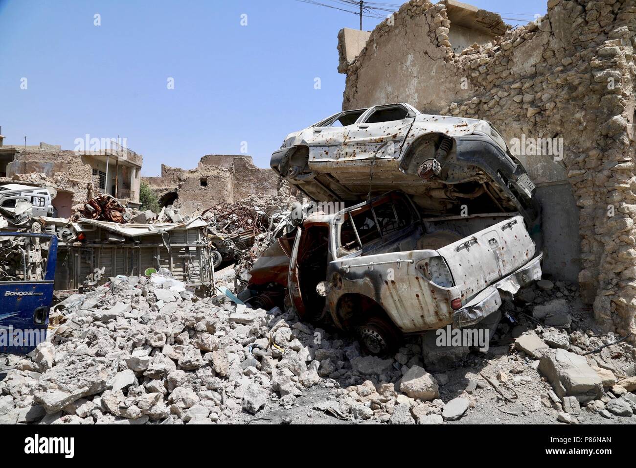 Mosul. 5th July, 2018. Photo taken on July 5, 2018 shows debris of the collapsed buildings in the old city of Mosul, Iraq. One year after the Iraqi forces liberated the city of Mosul from Islamic State (IS) militants, tens of thousands of displaced residents are still living in tents, suffering the scorching summer with a temperature of over 50 degrees Celsius. TO GO WITH Feature: One year on, tens of thousands of Iraqis remain displaced from homes in Mosul Credit: Khalil Dawood/Xinhua/Alamy Live News Stock Photo