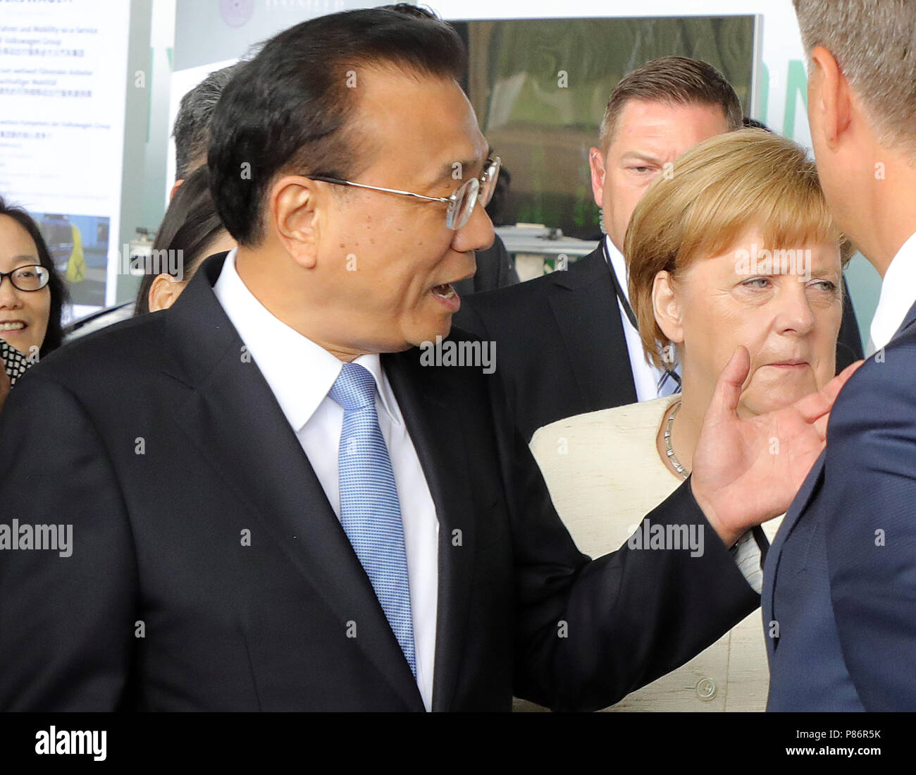 Berlin, Germany. 10th July, 2018. Li Keqiang (L), Premier of the People's Republic of China, and German Chancellor Angela Merkel of the Christian Democratic Union (CDU) attend a presentation about autonomous driving on the former Tempelhof Airport in the course of the 5th German-Chinese government consultations. Credit: Wolfgang Kumm/dpa/Alamy Live News Stock Photo