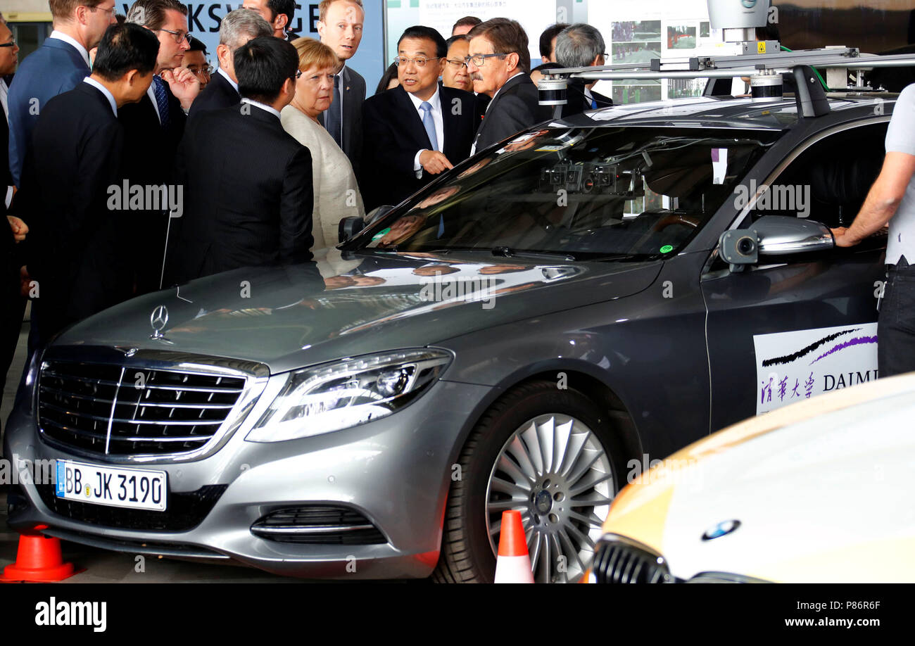Berlin, Germany. 10th July, 2018. Chinese Premier Li Keqiang and German Chancellor Angela Merkel of the Christian Democratic Union (CDU) attend a presentation for autonomous driving at Tempelhof airport in Berlin. A Mercedes Benz S-Class VRU stands next to them as a test vehicle. The visit takes place in the course of the 5th German-Chinese government consultations. Credit: Fabrizio Bensch/REUTERS POOL/dpa/Alamy Live News Stock Photo