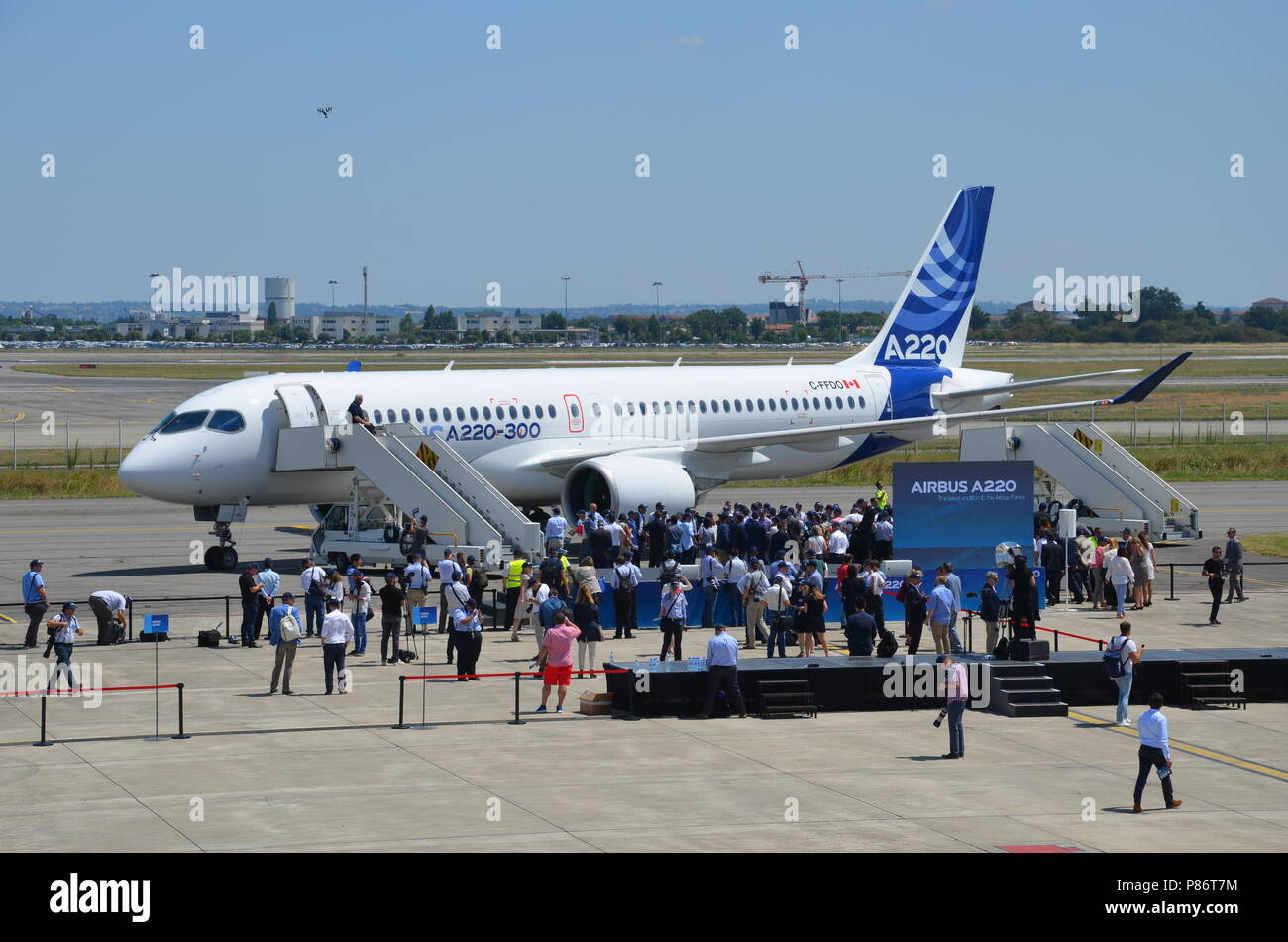 Toulouse, France. 10th July, 2018. Journalists stand in front of an aircraft of the model A220-300 on the runway at the Airbus delivery centre near Toulouse. The European aircraft manufacturer Airbus renames the medium haul destinations series C-Series taken over by Bombardier into A220. Credit: Sebastian Kunigkeit/dpa/Alamy Live News Stock Photo