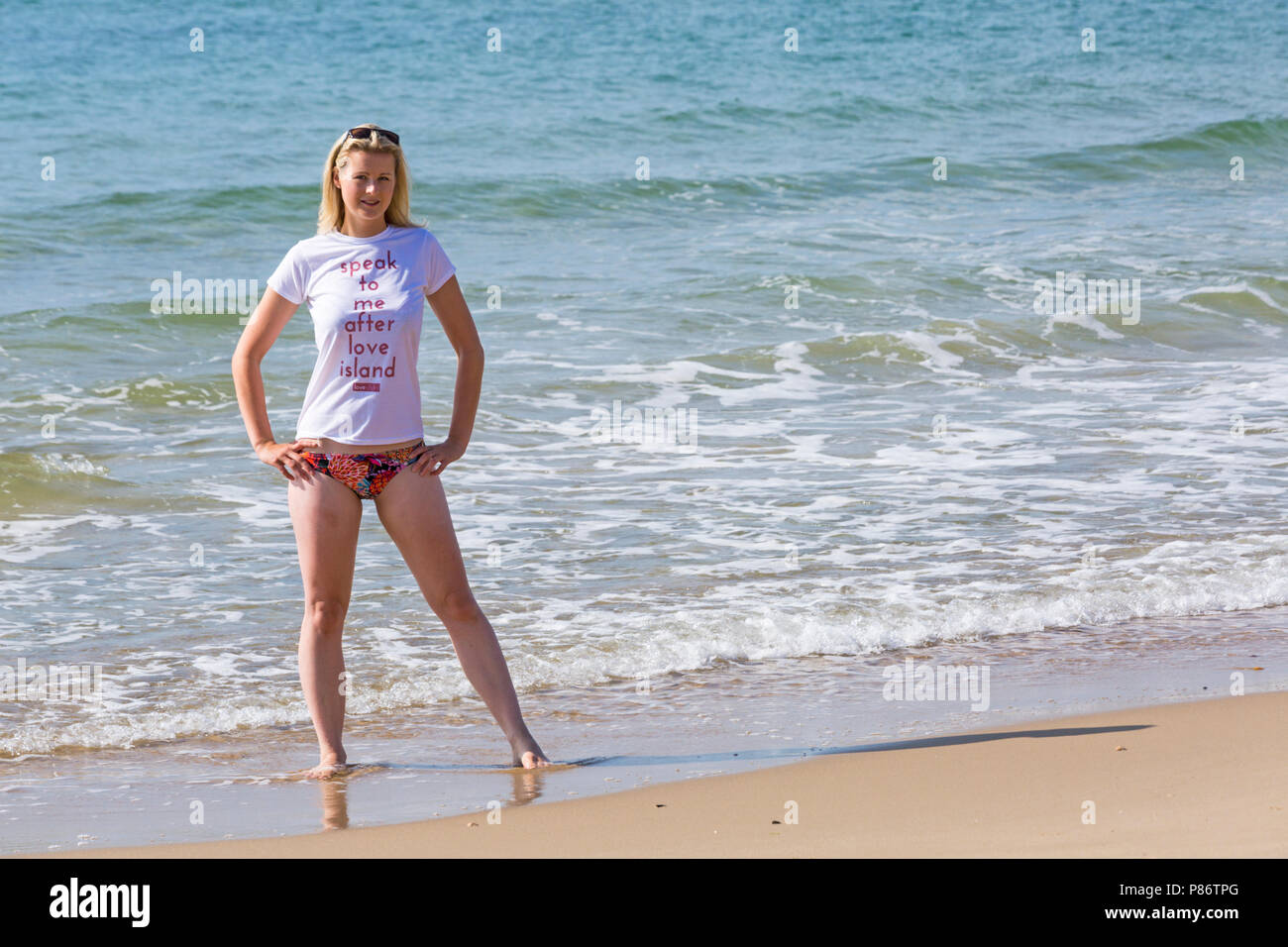Bournemouth, Dorset, UK. 10th July 2018. UK weather: after a cloudy start, another hot sunny day. Model Leanne Cable enjoys the sunshine at Alum Chine beach. Credit: Carolyn Jenkins/Alamy Live News Stock Photo