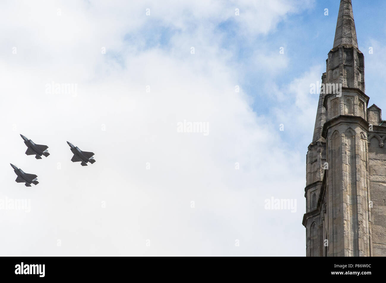 Windsor, UK. 10th July, 2018. Three of Britain’s new F-35 Lightning stealth fighter jets, flying for the first time in a public event, pass over the parish church of St John the Baptist in Windsor as part of a flypast to mark 100 years of the Royal Air Force. The RAF, the world’s first independent air force, was formed on 1st April 1918 when the Royal Flying Corps and the Royal Naval Air Service were merged. Credit: Mark Kerrison/Alamy Live News Stock Photo