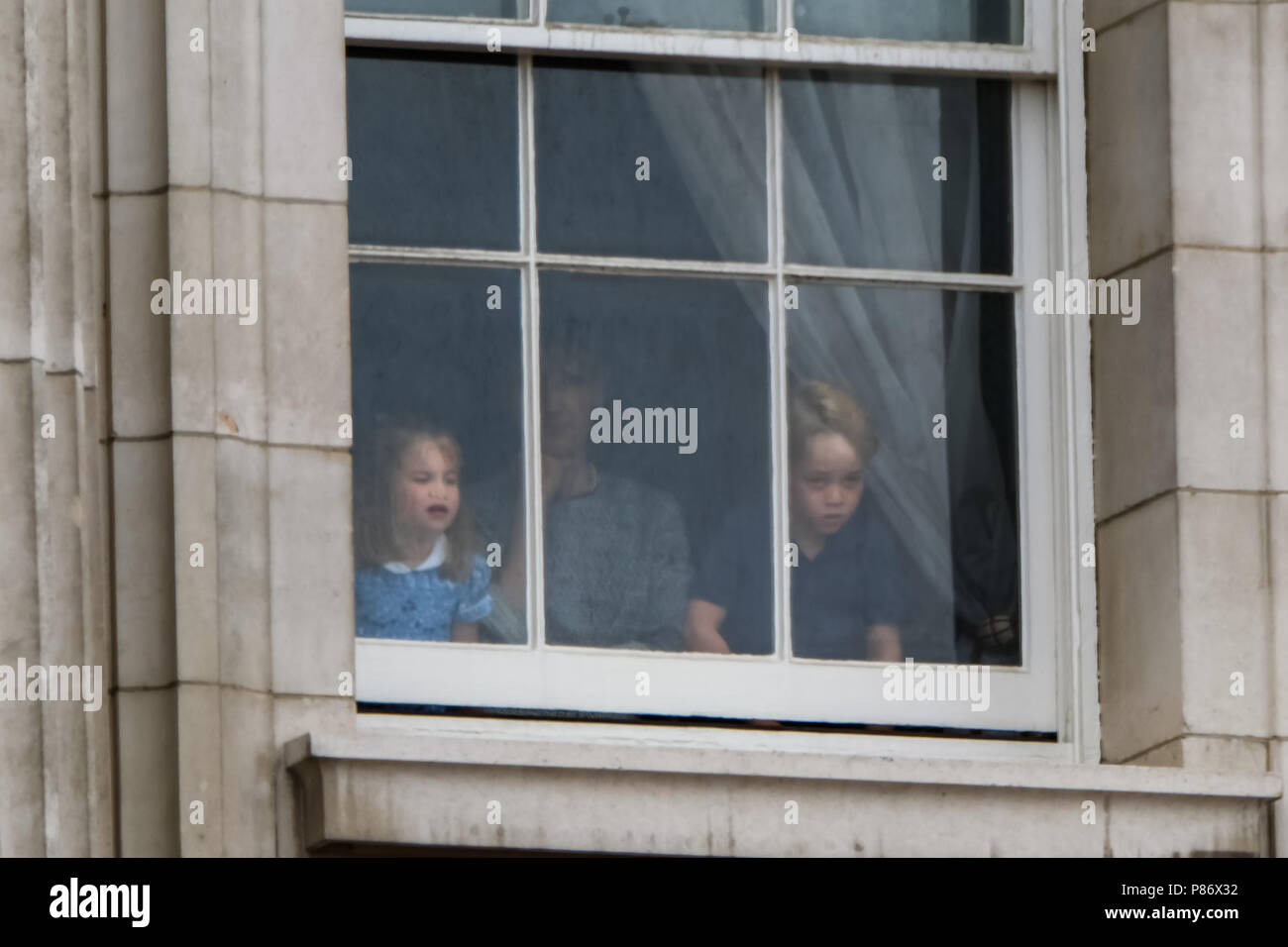 London, UK. 10th July, 2018. Prince George and Princess Charlotte watching the RAF 100 Flypast from a window in Buckingham Palace MUSTCREDIT: Stuart Rose/Alamy Live News Stock Photo