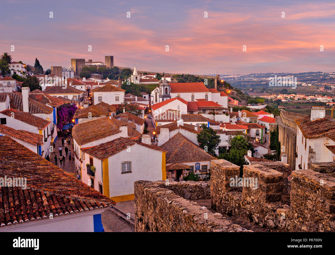 Portugal, Estremadura region, Costa da Prata, Obidos, medieval walled town, evening view of the Pousada, castle and cobbled street Stock Photo