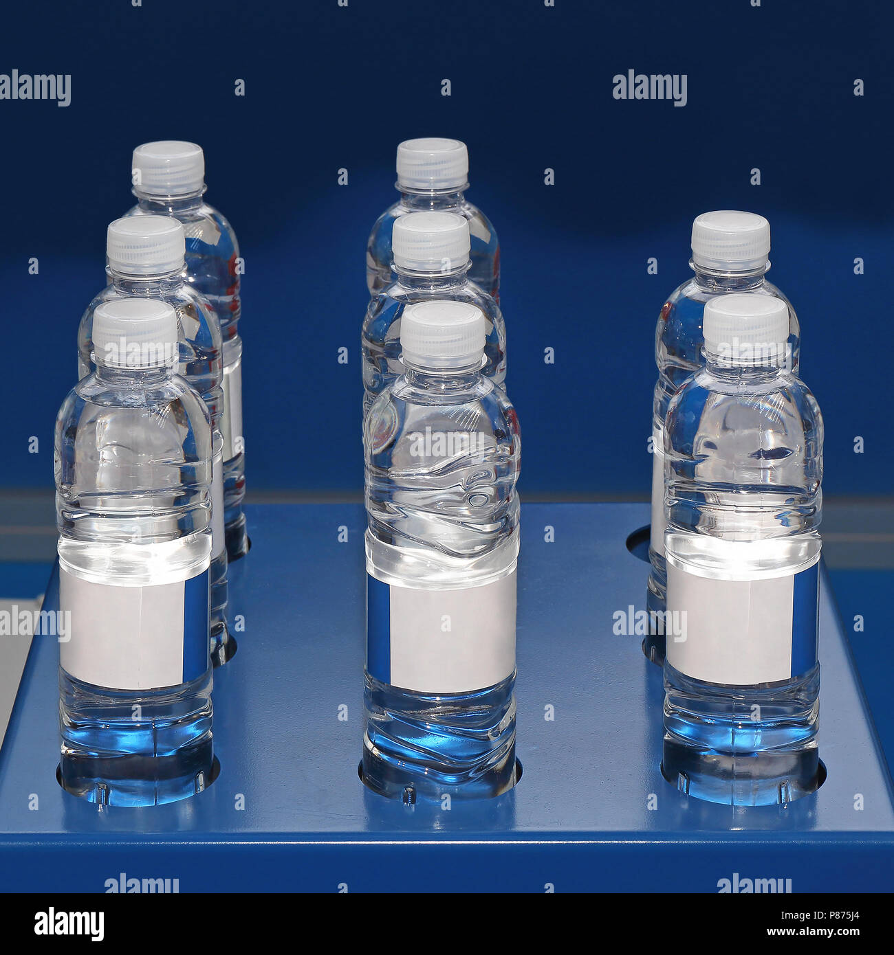 Water in Plastic Bottles at Blue Shelf Stock Photo
