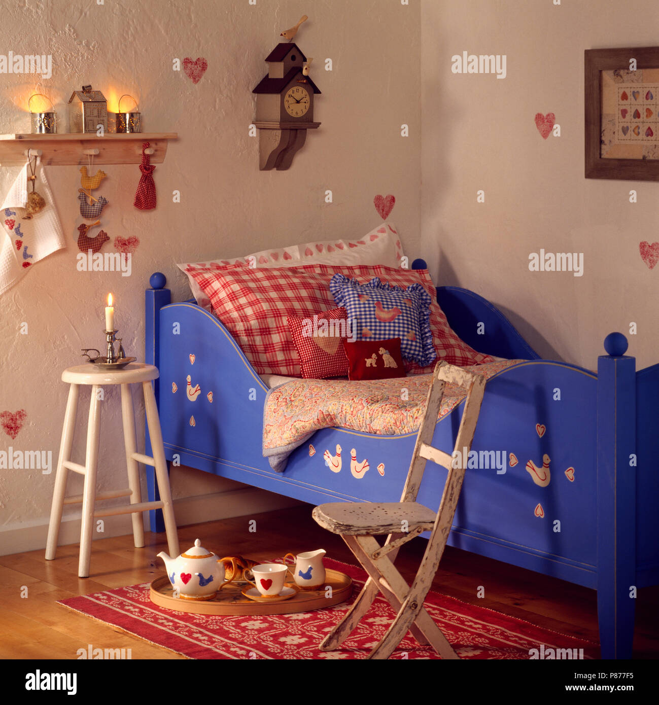Red And Blue Checked Pillows On Child S Blue Painted Sleigh