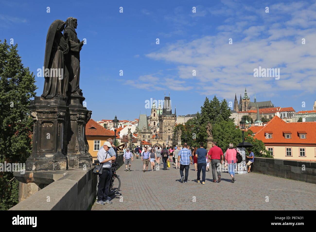 Statue of St Francis of Assisi with two angels, Charles Bridge, Prague, Czechia (Czech Republic), Europe Stock Photo