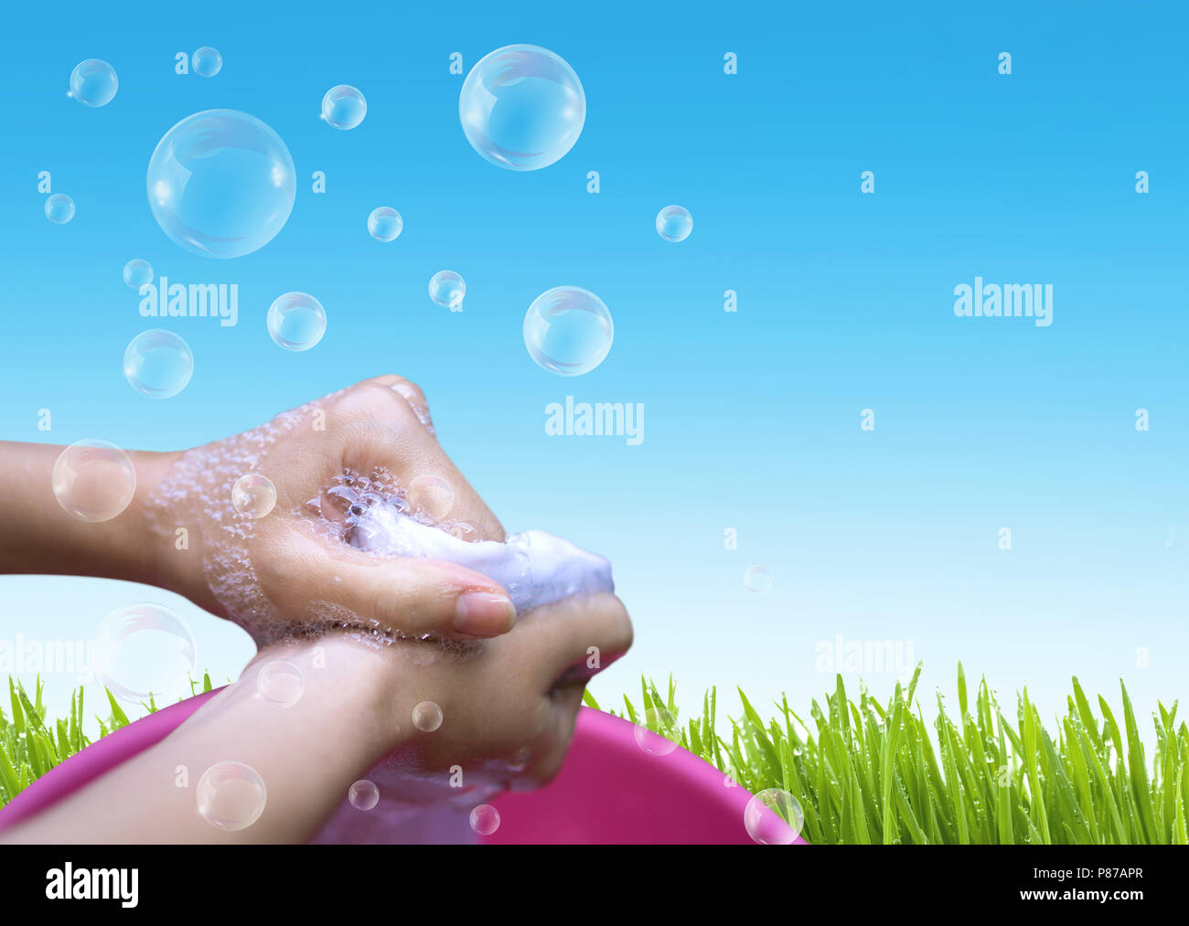 https://c8.alamy.com/comp/P87APR/female-hand-washing-clothes-in-the-pink-basin-with-clear-bubble-soap-against-blue-sky-P87APR.jpg