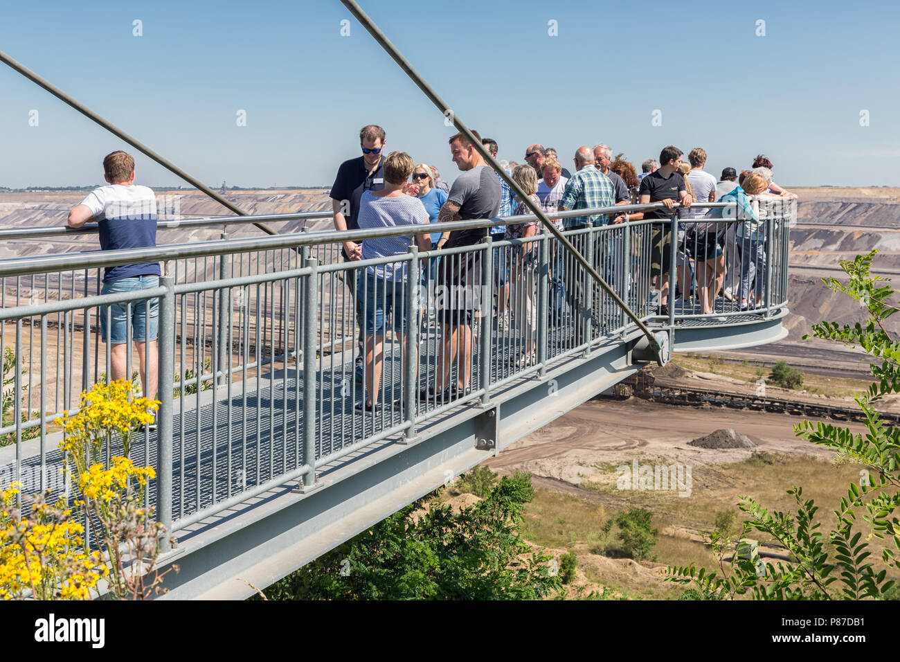 People visiting viewpoint with skywalk at Garzweiler brown-coal mine Germany Stock Photo