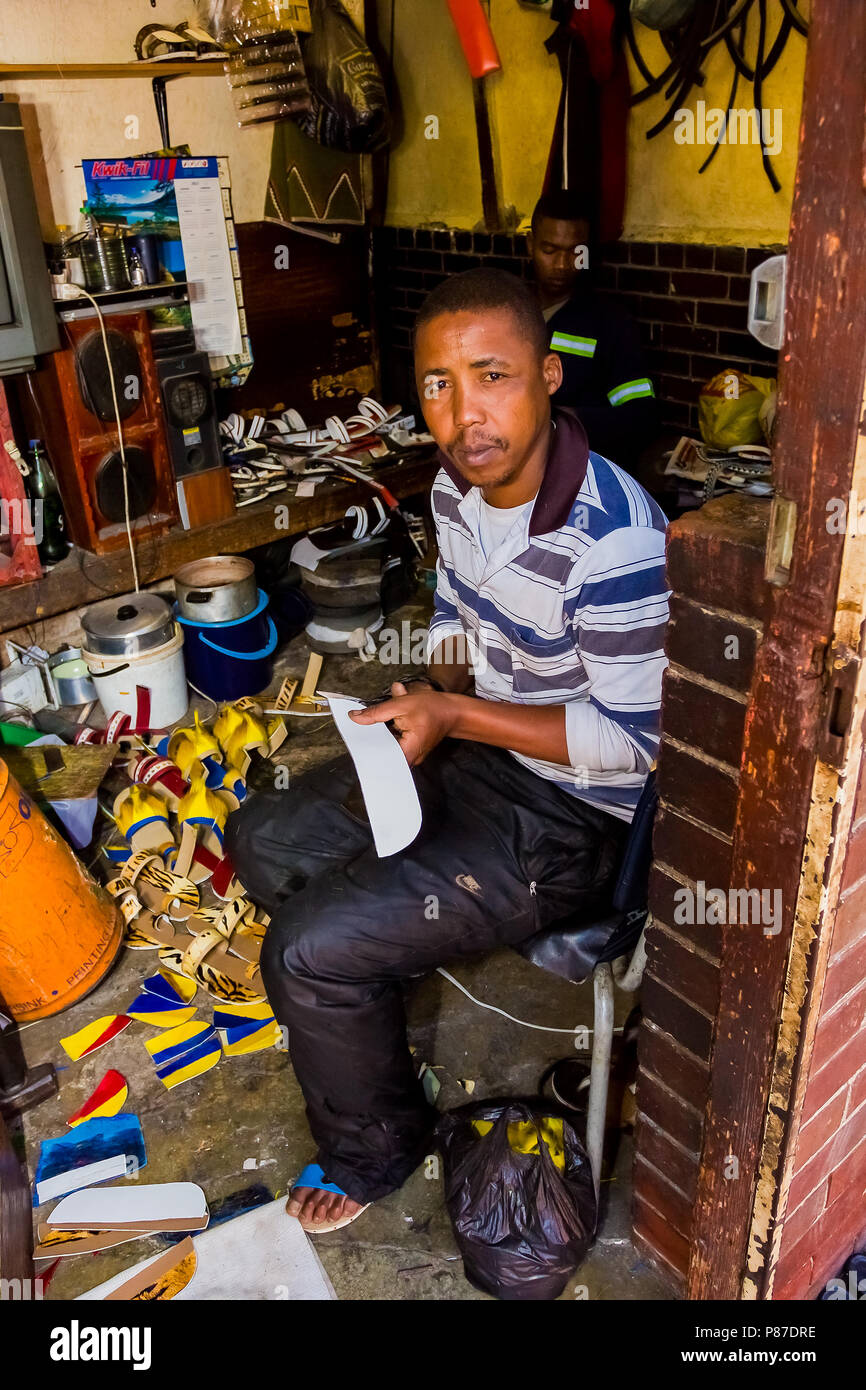 Johannesburg, South Africa, April 24, 2013, Man making shoes and sandlas at Traditional Medicine Marketplace in Johannesburg CBD Stock Photo