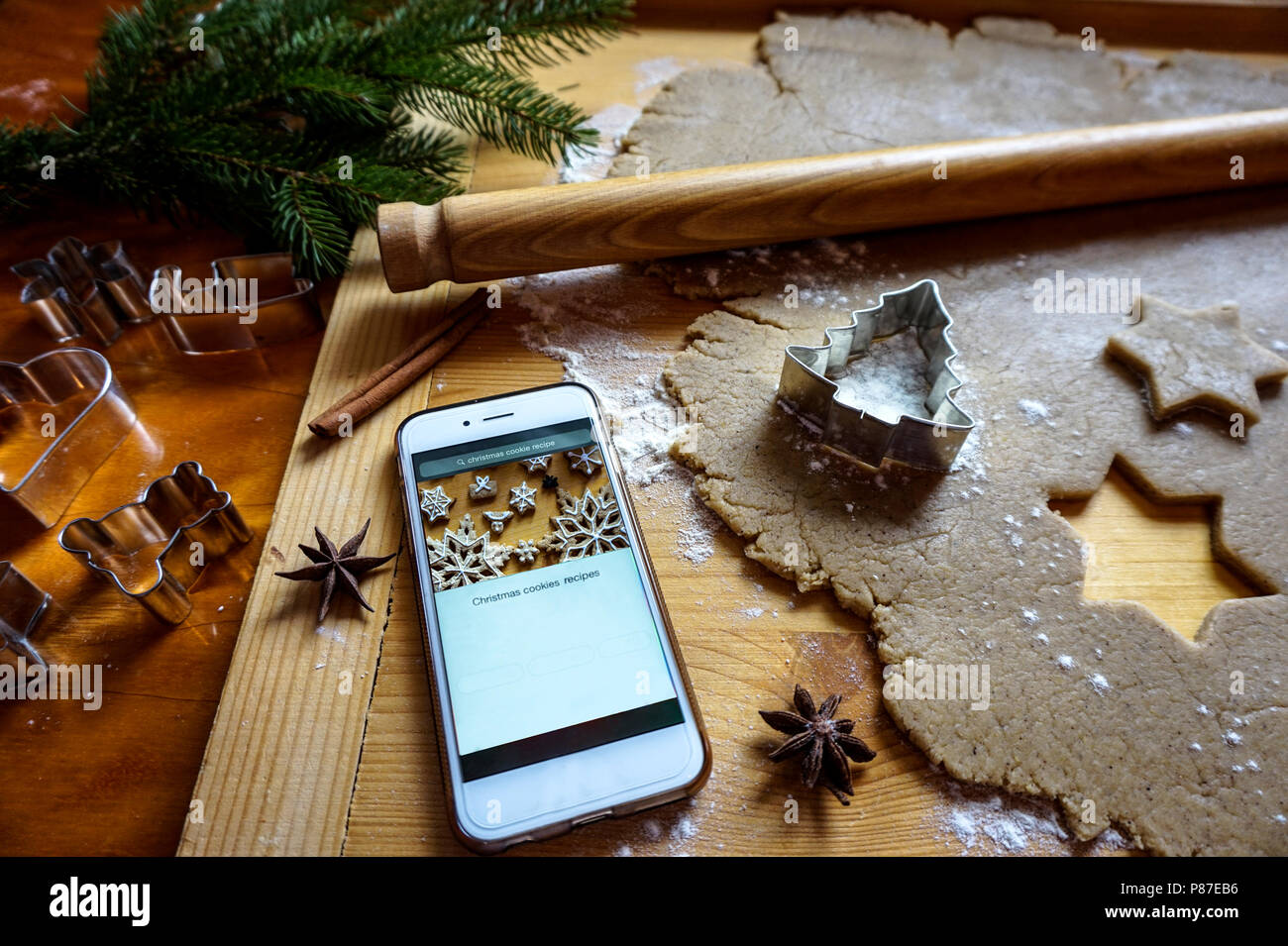 Baking gingerbread with smart phone online recipe Stock Photo - Alamy