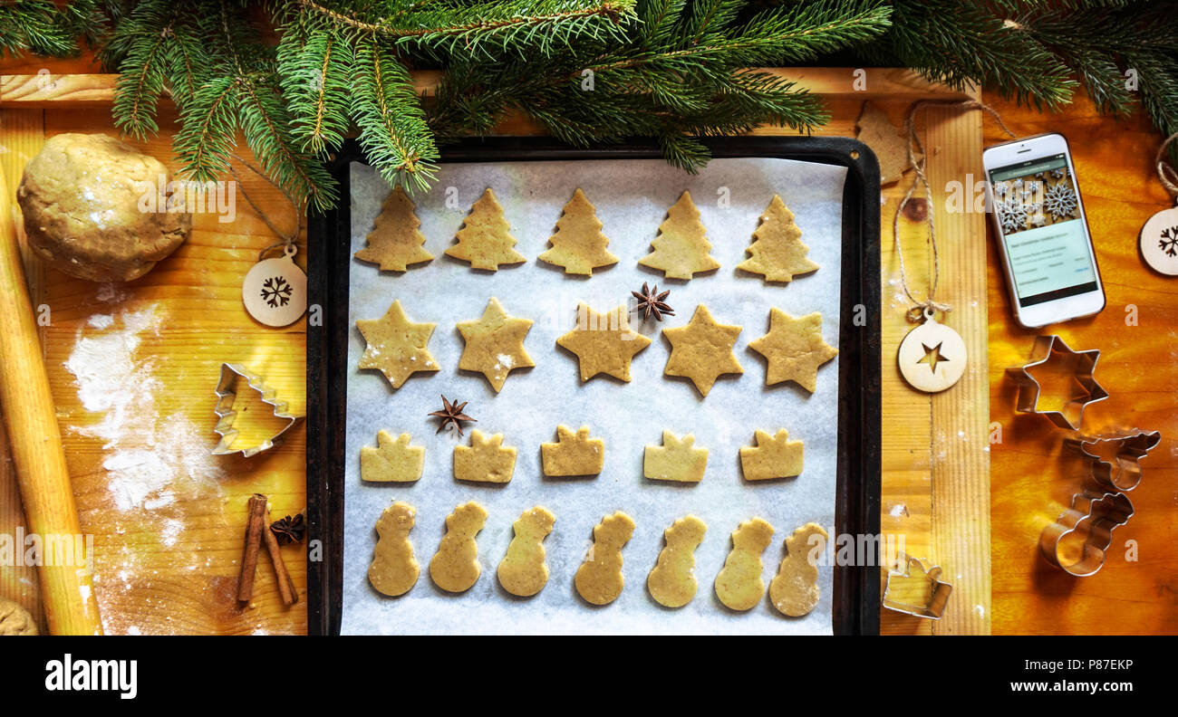 gingerbread in the cake pan ready for bake in the oven with onlinesmartphone recipe Stock Photo