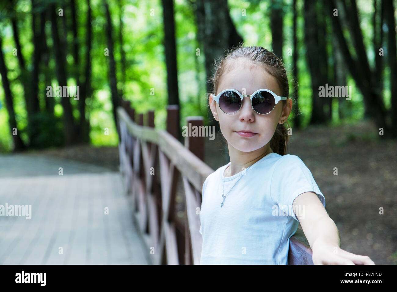 portrait of cute smiling girl in the forest in sunglasses Stock Photo ...