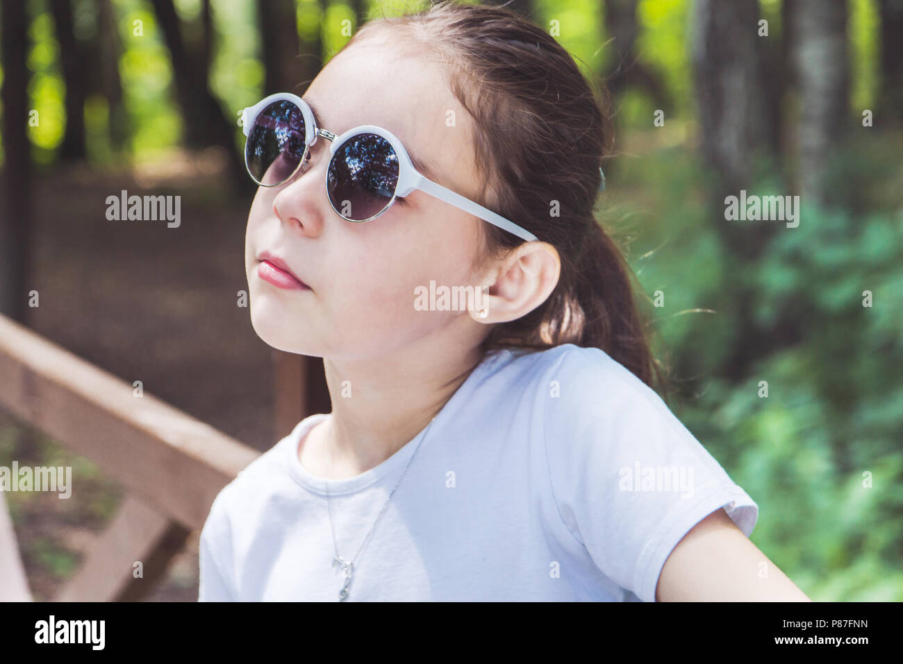 portrait of cute smiling girl in the forest in sunglasses Stock Photo ...