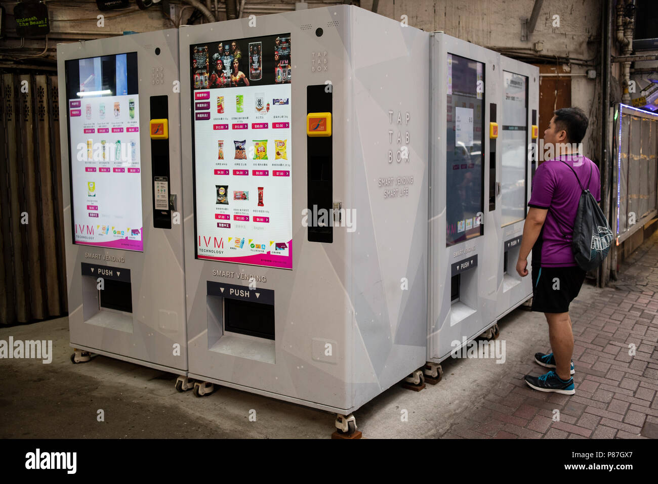 A man purchases snacks and beverages at a new interactive digital