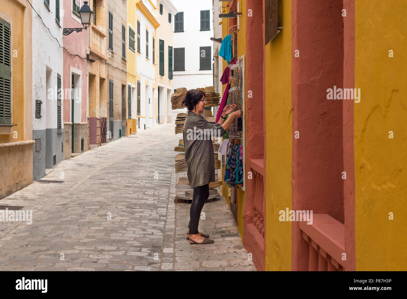 A woman shopping for souvenirs in Ciutadella, Menorca Stock Photo