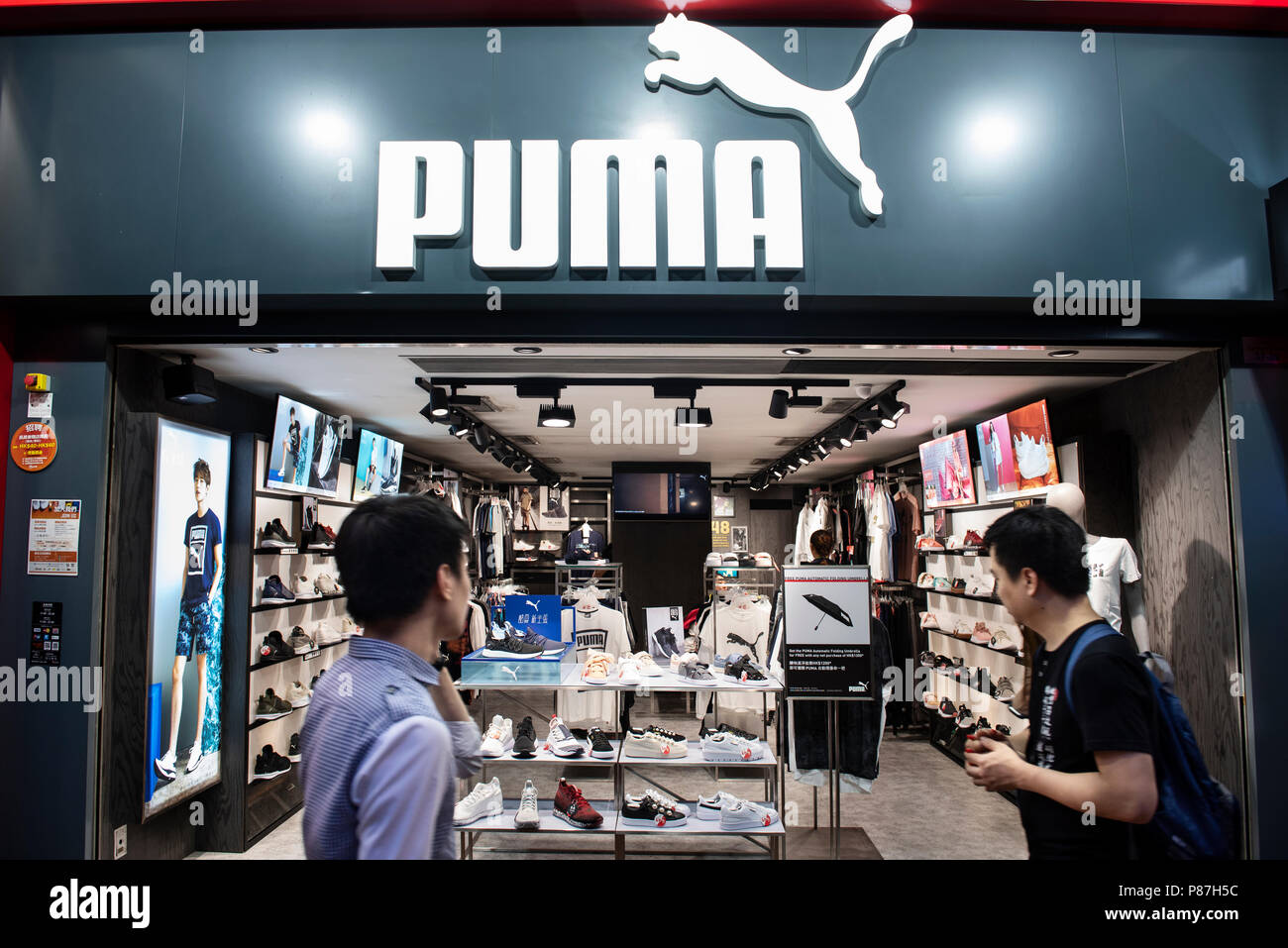 Pedestrians walk by a Puma, German multinational sportswear brand, shop in  Hong Kong Stock Photo - Alamy